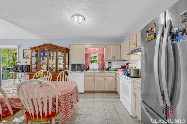 5480 Apache Trl, Gainesville, GA 30506 - kitchen featuring appliances with stainless steel finishes, under cabinet range hood, light countertops, a textured ceiling, and light tile patterned floors