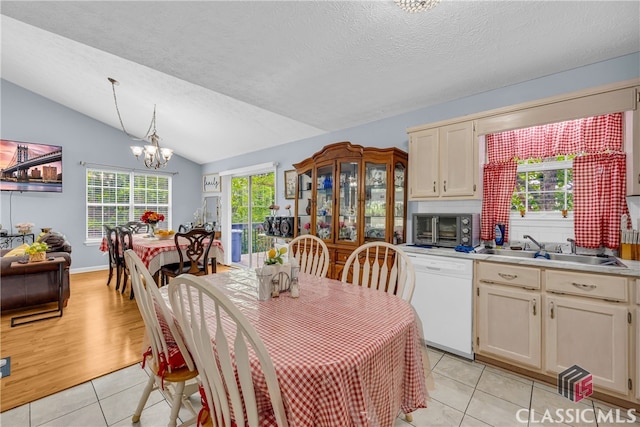 5480 Apache Trl, Gainesville, GA 30506 - dining space featuring light tile patterned floors, lofted ceiling, a chandelier, and a textured ceiling