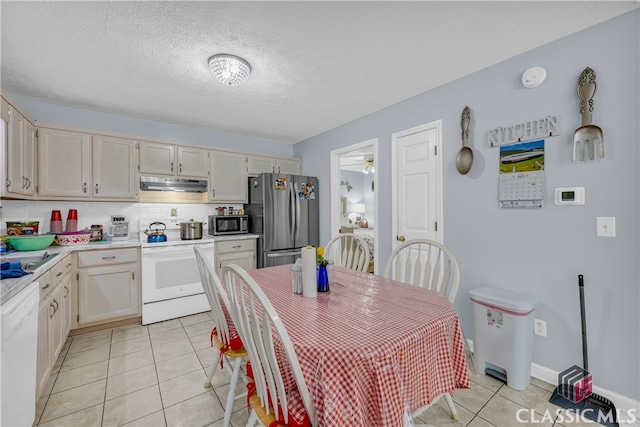 5480 Apache Trl, Gainesville, GA 30506 - kitchen with appliances with stainless steel finishes, under cabinet range hood, light tile patterned floors, light countertops, and decorative backsplash