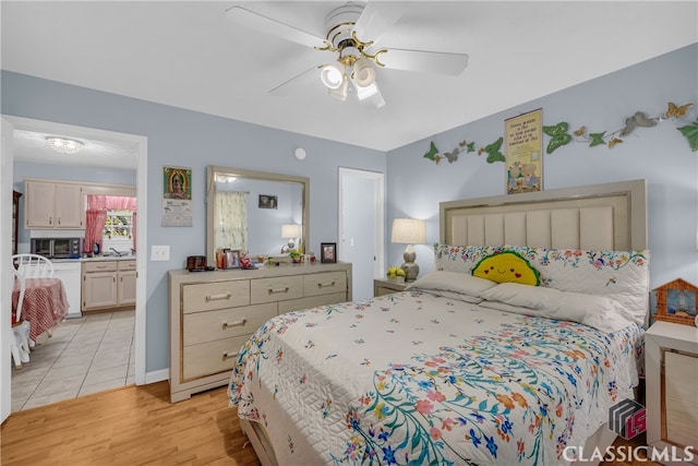 5480 Apache Trl, Gainesville, GA 30506 - bedroom with light wood-style flooring, ensuite bath, and a ceiling fan
