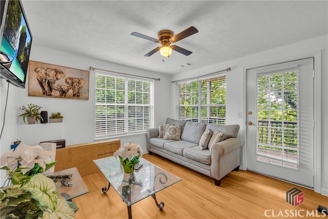 5480 Apache Trl, Gainesville, GA 30506 - living area featuring a textured ceiling, a ceiling fan, and wood finished floors