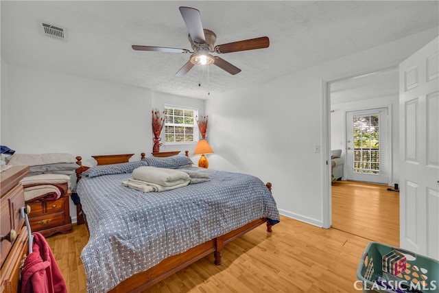 5480 Apache Trl, Gainesville, GA 30506 - bedroom featuring light wood-style floors, ceiling fan, and a textured ceiling