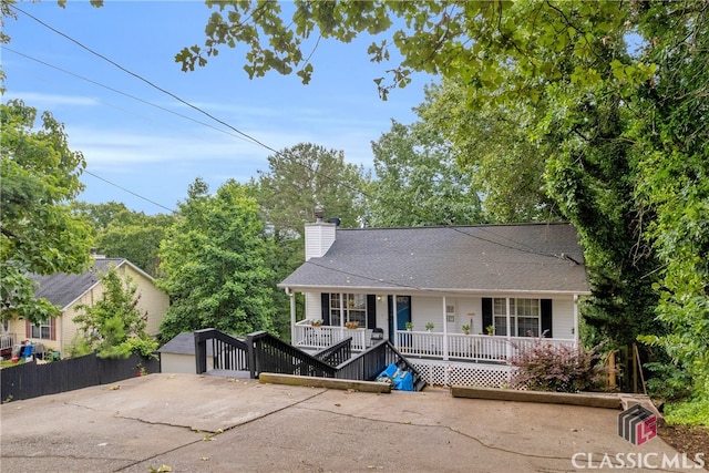 5480 Apache Trl, Gainesville, GA 30506 - view of front of property featuring covered porch, a chimney, an outdoor structure, and roof with shingles