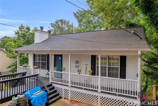5480 Apache Trl, Gainesville, GA 30506 - view of front of home with covered porch, a shingled roof, and a chimney