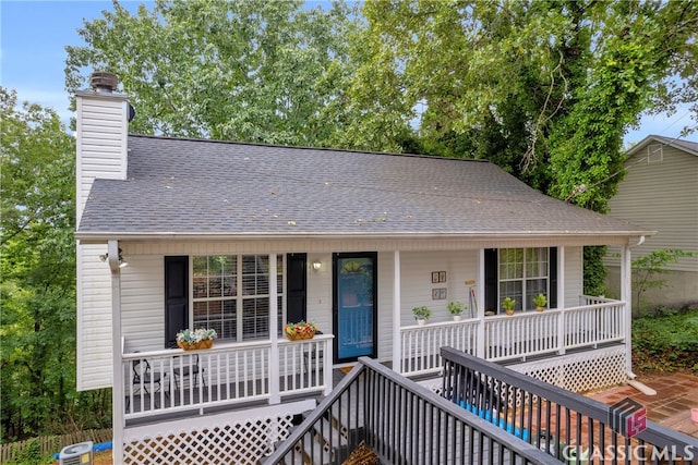 5480 Apache Trl, Gainesville, GA 30506 - view of front of house featuring covered porch, a shingled roof, and a chimney