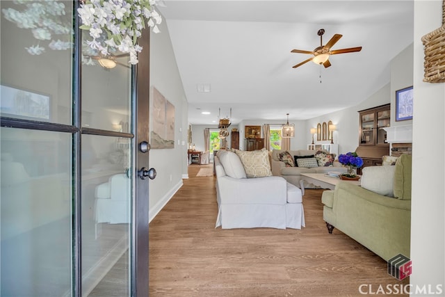 120 Peach Ln, Royston, GA 30662 - living area featuring wood finished floors, vaulted ceiling, and a ceiling fan
