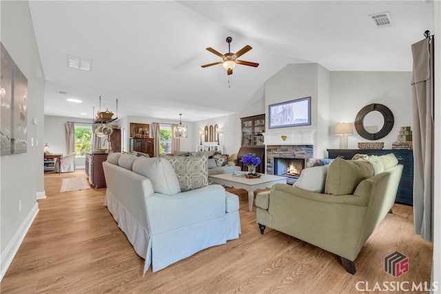 120 Peach Ln, Royston, GA 30662 - living area with light wood-style floors, ceiling fan, a stone fireplace, and vaulted ceiling