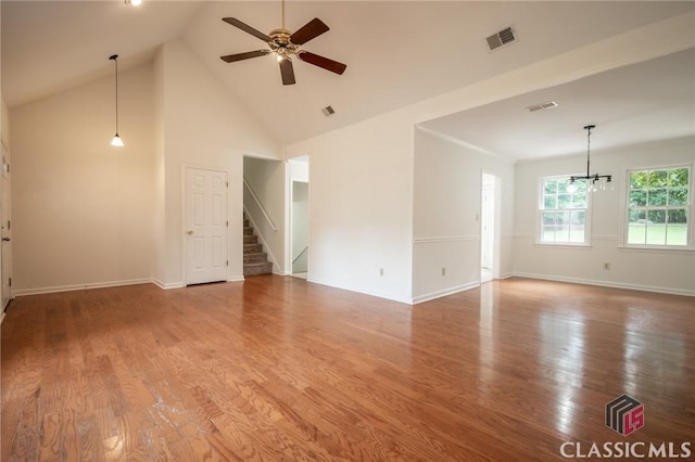170 Chadds Walk, Athens, GA 30606 - unfurnished living room with ceiling fan, wood finished floors, a chandelier, stairway, and high vaulted ceiling