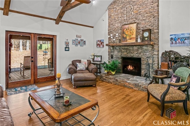 1233 Staplers Bridge Rd, Nicholson, GA 30565 - living area featuring french doors, beamed ceiling, wood finished floors, a ceiling fan, and high vaulted ceiling