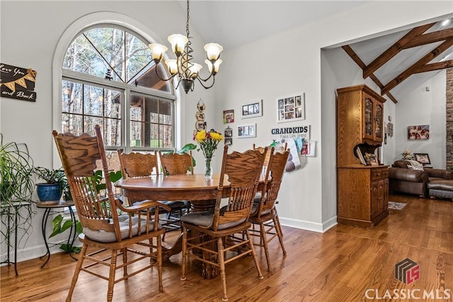 1233 Staplers Bridge Rd, Nicholson, GA 30565 - dining space with vaulted ceiling, wood finished floors, and a chandelier