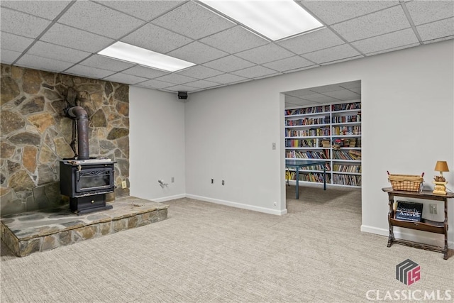 1233 Staplers Bridge Rd, Nicholson, GA 30565 - unfurnished living room featuring carpet, a wood stove, and a paneled ceiling