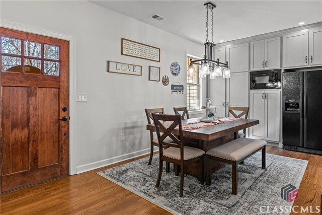 1233 Staplers Bridge Rd, Nicholson, GA 30565 - dining room with plenty of natural light, wood finished floors, a chandelier, and recessed lighting