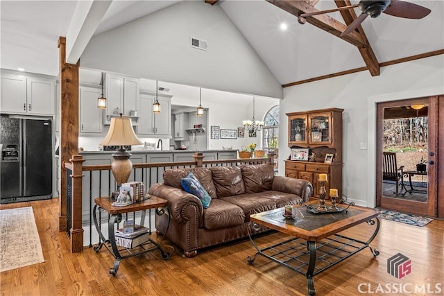 1233 Staplers Bridge Rd, Nicholson, GA 30565 - living area featuring high vaulted ceiling, light wood-type flooring, ceiling fan, beam ceiling, and a chandelier