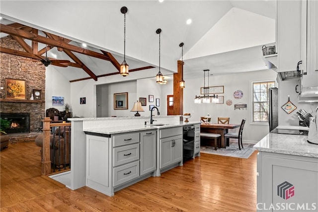 1233 Staplers Bridge Rd, Nicholson, GA 30565 - kitchen with gray cabinets, high vaulted ceiling, open floor plan, light wood-type flooring, and light stone countertops