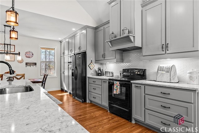 1233 Staplers Bridge Rd, Nicholson, GA 30565 - kitchen featuring gray cabinets, black appliances, wood finished floors, tasteful backsplash, and vaulted ceiling