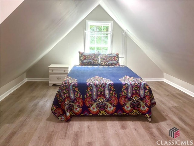 2181 Whippoorwill Rd, Bishop, GA 30621 - bedroom featuring vaulted ceiling and wood finished floors
