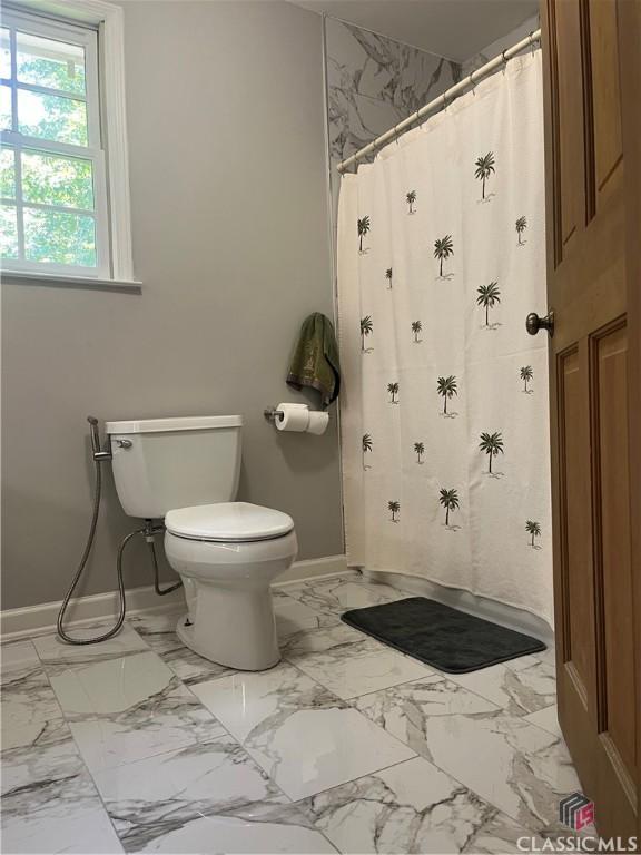 2181 Whippoorwill Rd, Bishop, GA 30621 - bathroom featuring marble look tile flooring and curtained shower