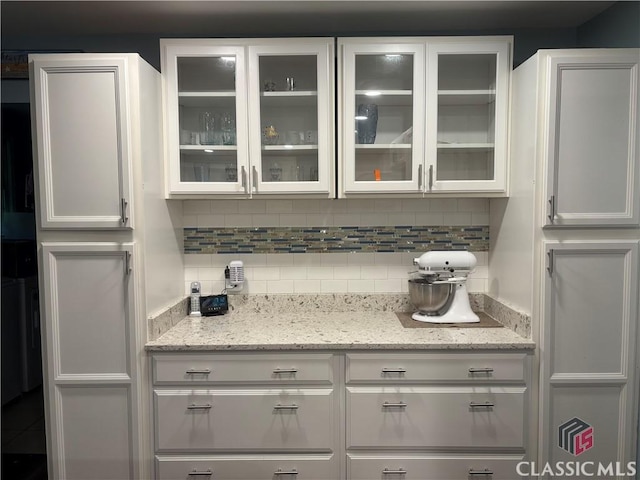 2181 Whippoorwill Rd, Bishop, GA 30621 - kitchen featuring white cabinetry, backsplash, glass insert cabinets, and light stone countertops