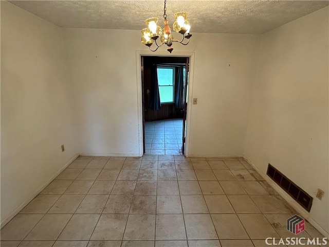 220 Swanson Dr W Unit 1, Athens, GA 30606 - spare room with a textured ceiling, light tile patterned flooring, and a chandelier