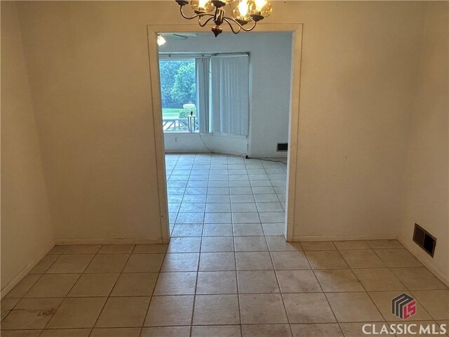 220 Swanson Dr W Unit 1, Athens, GA 30606 - empty room with light tile patterned floors and a chandelier