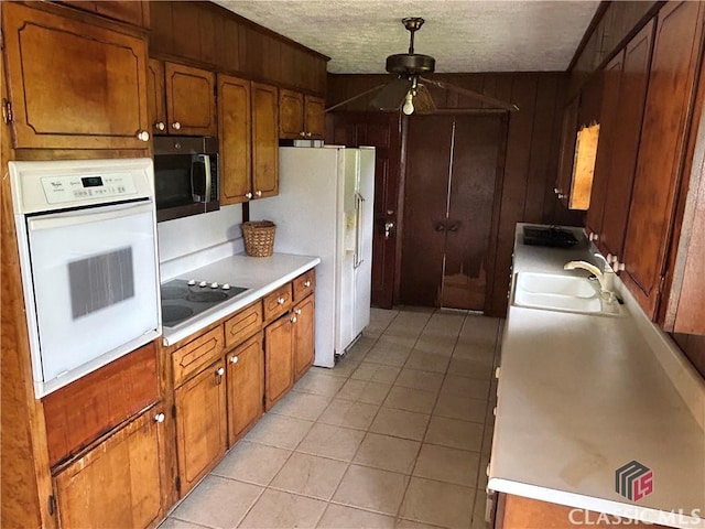220 Swanson Dr W Unit 1, Athens, GA 30606 - kitchen with white appliances, ceiling fan, light tile patterned floors, light countertops, and a textured ceiling
