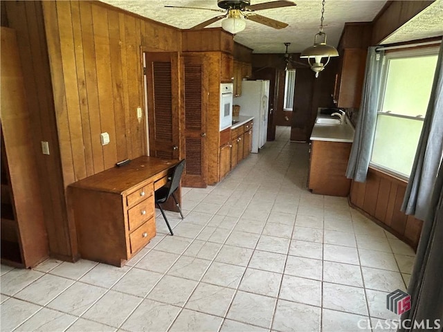 220 Swanson Dr W Unit 1, Athens, GA 30606 - kitchen featuring wood walls, light countertops, ceiling fan, brown cabinets, and white appliances