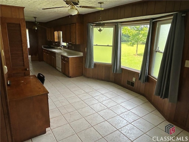 220 Swanson Dr W Unit 1, Athens, GA 30606 - kitchen featuring wooden walls, white dishwasher, ceiling fan, a textured ceiling, and light countertops