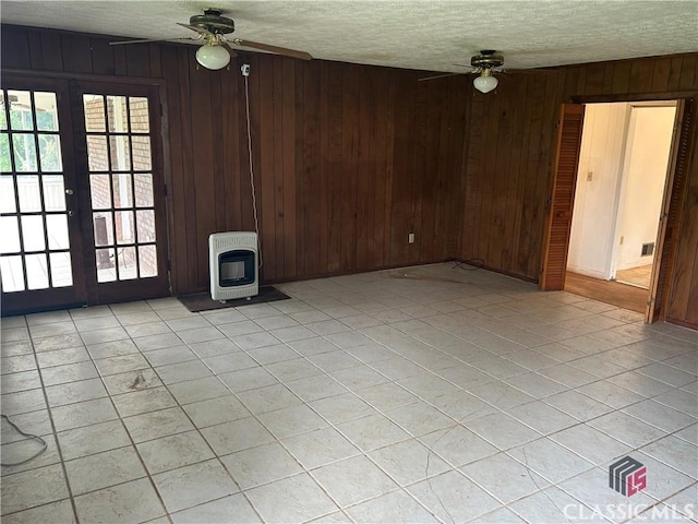 220 Swanson Dr W Unit 1, Athens, GA 30606 - unfurnished living room with heating unit, ceiling fan, a textured ceiling, french doors, and wooden walls