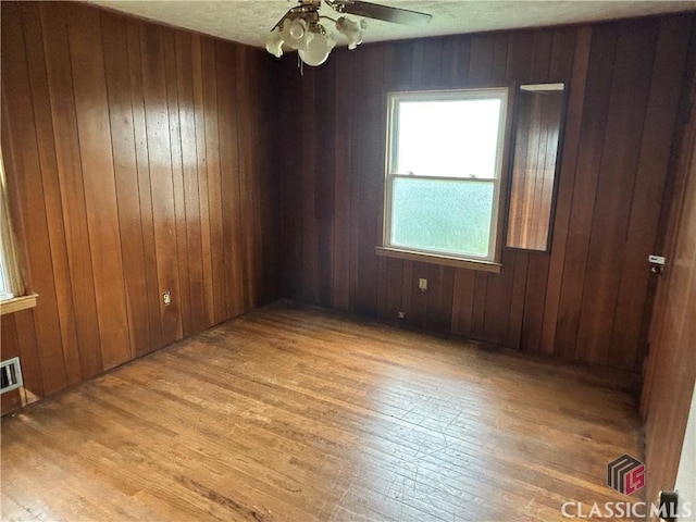 220 Swanson Dr W Unit 1, Athens, GA 30606 - unfurnished room with light wood-type flooring, a ceiling fan, and wooden walls