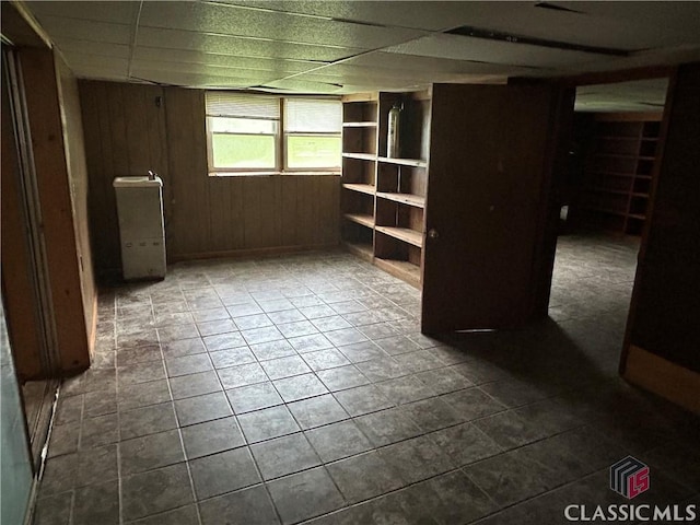 220 Swanson Dr W Unit 1, Athens, GA 30606 - empty room featuring dark tile patterned floors, a paneled ceiling, and wood walls