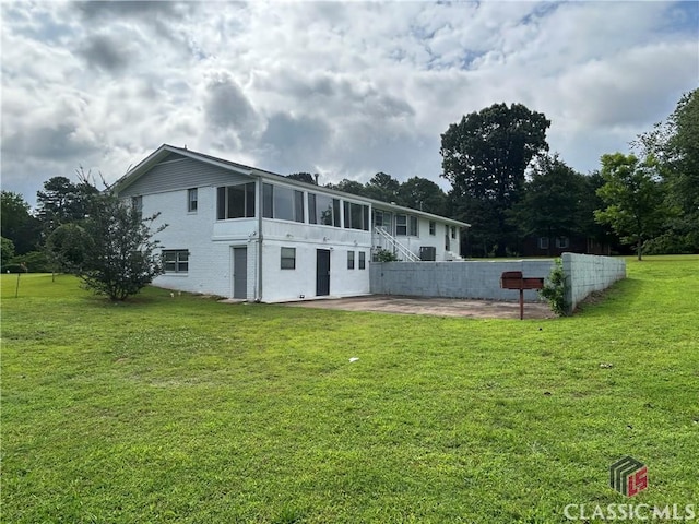 220 Swanson Dr W Unit 1, Athens, GA 30606 - back of property featuring a patio area, a yard, a sunroom, and brick siding
