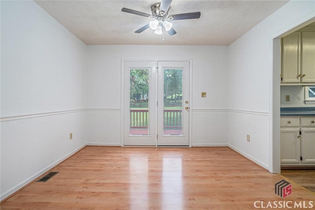 148 Hunters Crossing Rd, Athens, GA 30606 - unfurnished dining area with light wood-style flooring, a ceiling fan, and a textured ceiling