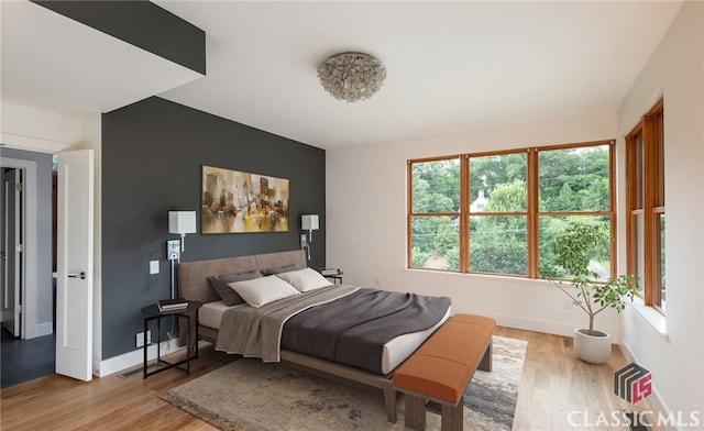 497 W Rutherford St, Athens, GA 30606 - bedroom with light wood finished floors and baseboards