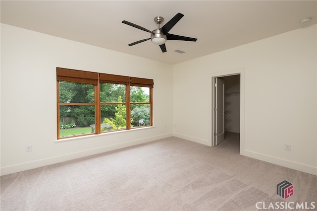 497 W Rutherford St, Athens, GA 30606 - unfurnished bedroom featuring light colored carpet, a ceiling fan, and a walk in closet