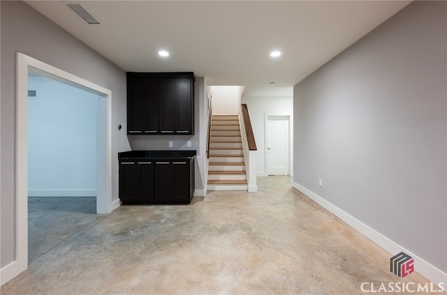 497 W Rutherford St, Athens, GA 30606 - unfurnished living room with stairway, concrete flooring, and recessed lighting