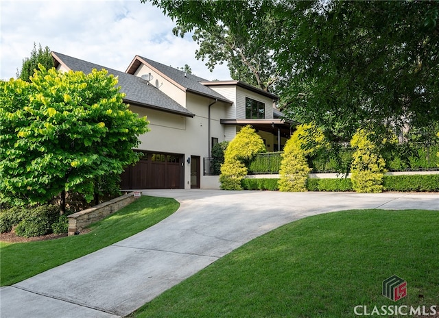 497 W Rutherford St, Athens, GA 30606 - view of front of property with concrete driveway, a front lawn, and stucco siding