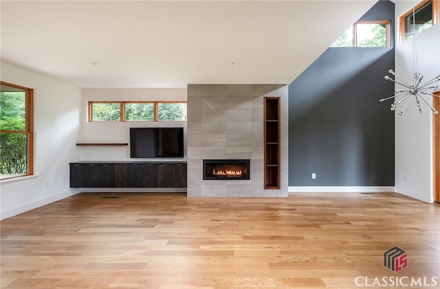 497 W Rutherford St, Athens, GA 30606 - unfurnished living room featuring wood finished floors, a fireplace, and a chandelier