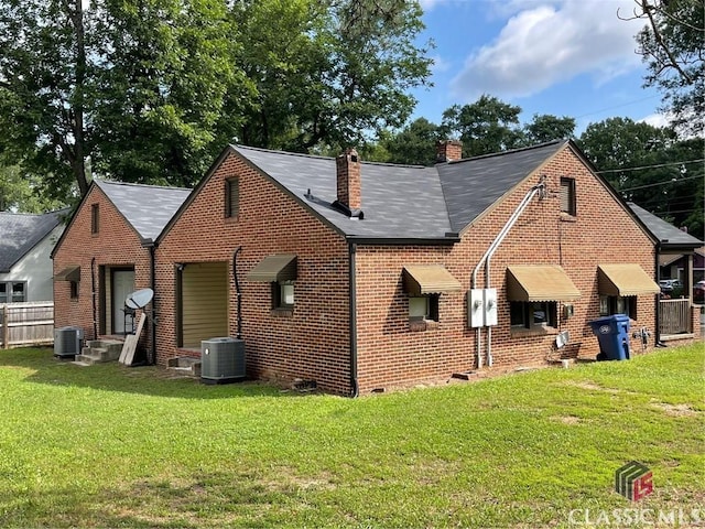 49 New St E, Winder, GA 30680 - back of property featuring a chimney, brick siding, a lawn, and crawl space