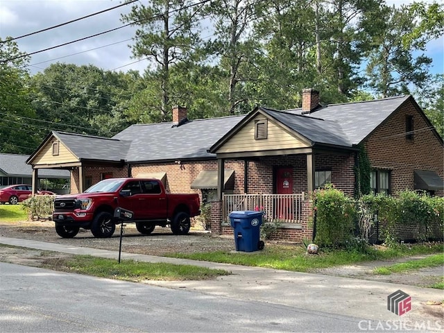 49 New St E, Winder, GA 30680 - view of front of property featuring brick siding and a chimney