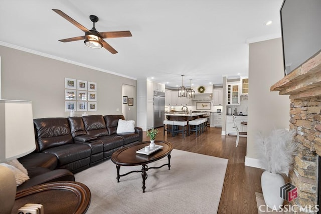 1232 Everton Pl, Cumming, GA 30041 - living room with ornamental molding, dark wood-style floors, a ceiling fan, recessed lighting, and a chandelier