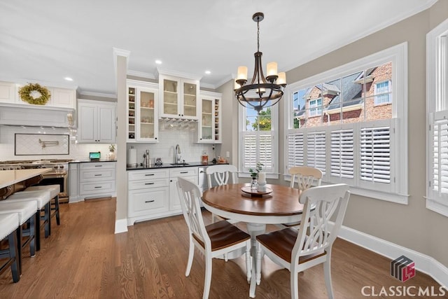 1232 Everton Pl, Cumming, GA 30041 - dining space featuring plenty of natural light, wood finished floors, a chandelier, crown molding, and recessed lighting