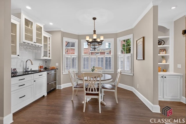 1232 Everton Pl, Cumming, GA 30041 - dining space with a chandelier, dark wood-style floors, wet bar, crown molding, and recessed lighting