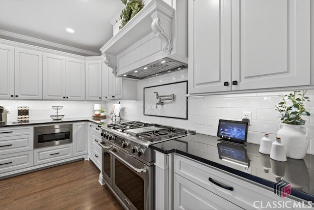 1232 Everton Pl, Cumming, GA 30041 - kitchen with stainless steel appliances, dark countertops, white cabinetry, backsplash, and recessed lighting