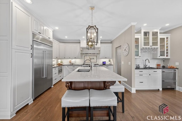 1232 Everton Pl, Cumming, GA 30041 - kitchen with stainless steel appliances, decorative backsplash, dark wood-type flooring, glass insert cabinets, and crown molding