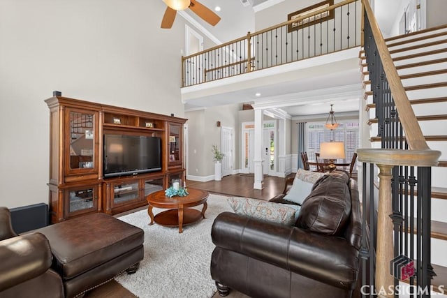 1232 Everton Pl, Cumming, GA 30041 - living room featuring crown molding, wood finished floors, stairs, ceiling fan, and a towering ceiling