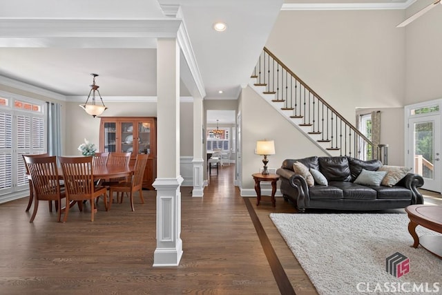 1232 Everton Pl, Cumming, GA 30041 - living area with stairs, dark wood finished floors, ornamental molding, recessed lighting, and decorative columns