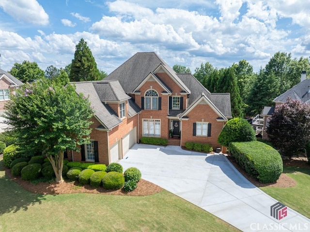 1232 Everton Pl, Cumming, GA 30041 - view of front facade with driveway, brick siding, and a front yard