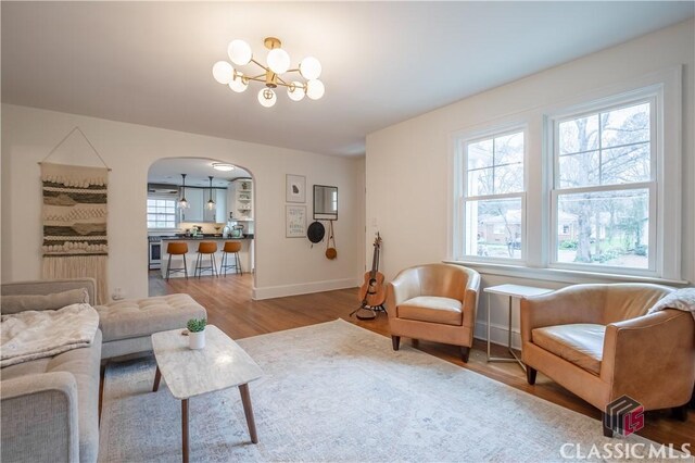 525 King Ave, Athens, GA 30606 - living room with arched walkways, wood finished floors, and a chandelier