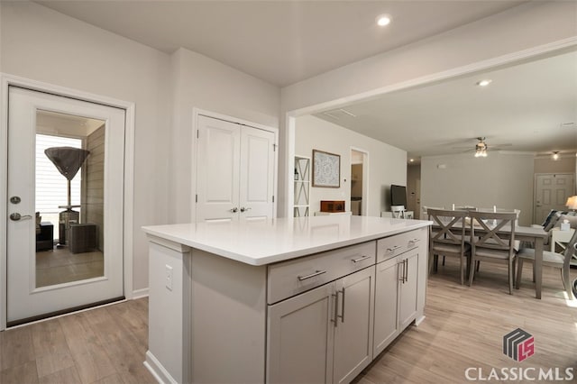 1260 Starboard Way, Greensboro, GA 30642 - kitchen featuring light wood-style floors, a kitchen island, light countertops, a ceiling fan, and gray cabinets
