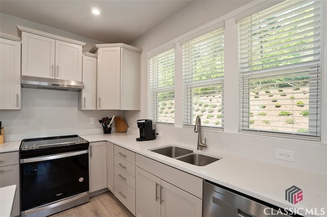 1260 Starboard Way, Greensboro, GA 30642 - kitchen with appliances with stainless steel finishes, under cabinet range hood, light countertops, white cabinetry, and light wood-style flooring